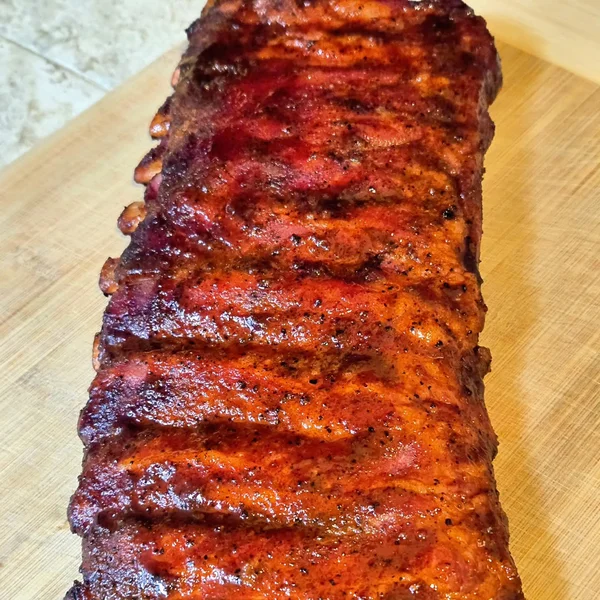 Full rack of smoked ribs with signature rub