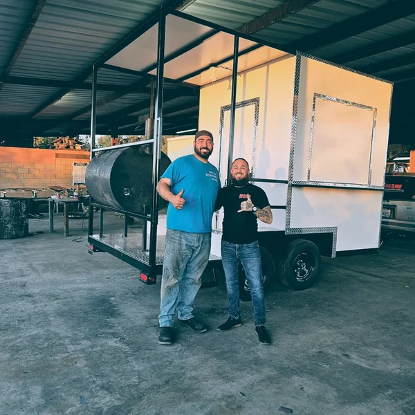 Mel's BBQ team with custom smoker trailer